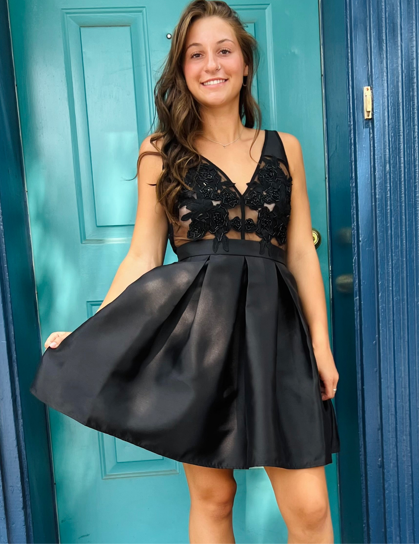 Black short dress with floral appliques over a sheer and sleeveless bodice with princess seams and a deep V-neckline (with a matching V-back)